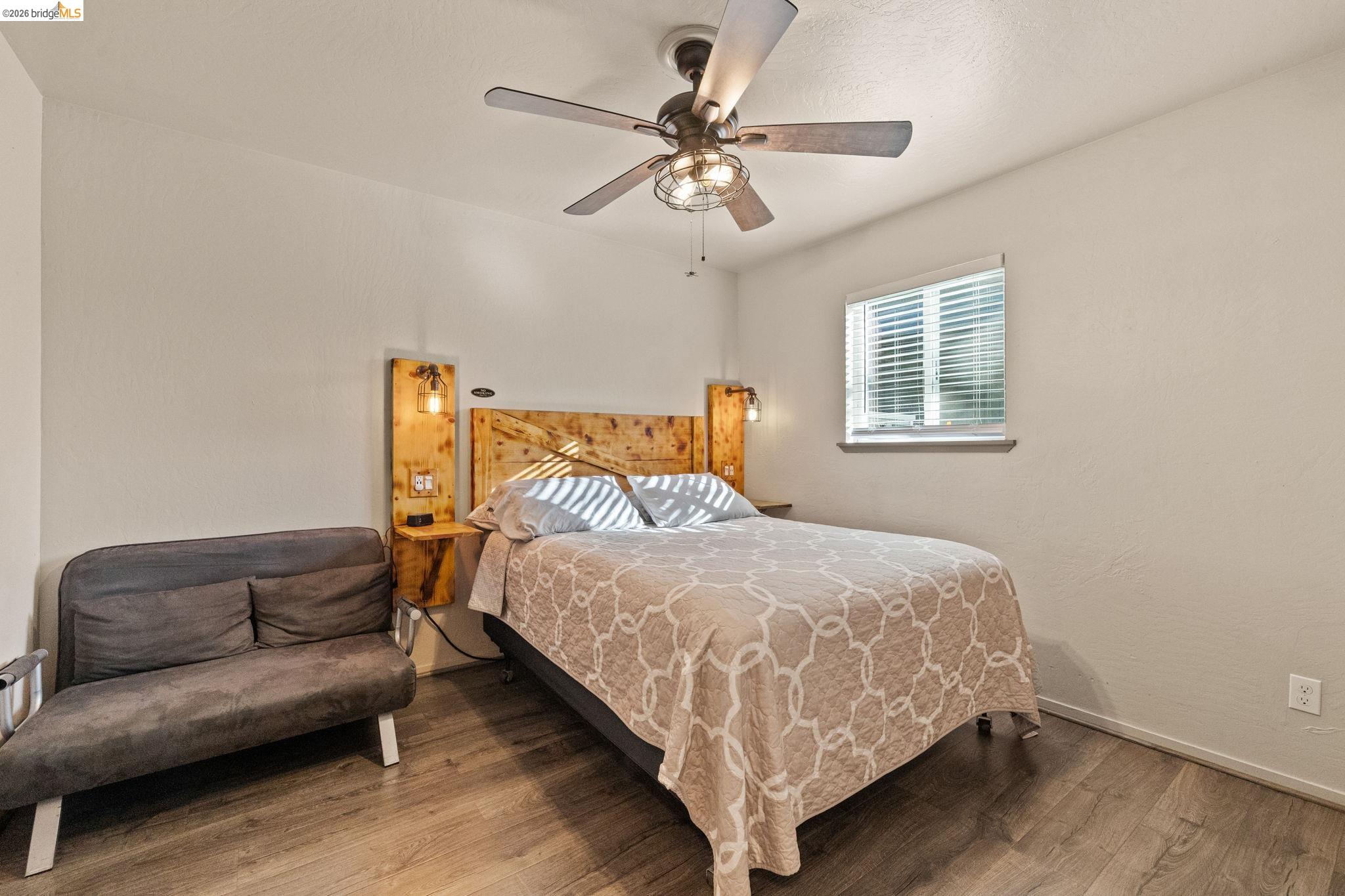 22941 Hudson Road Columbia, CA 95310 - Photo 20 of 34 a bedroom with a bed couch and window