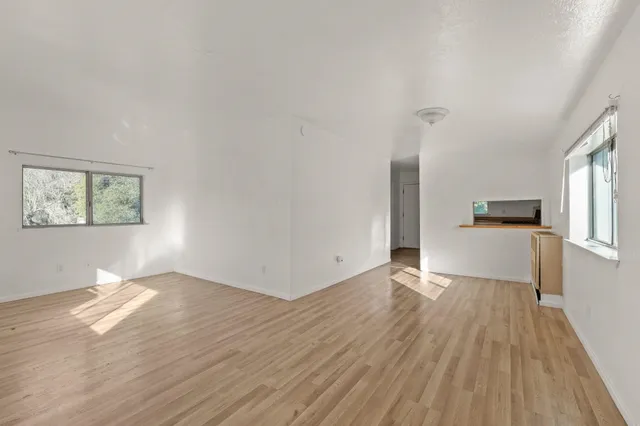 a view of a kitchen with wooden floor and a kitchen