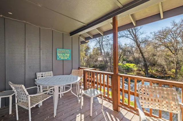 a view of a patio with a table and chairs