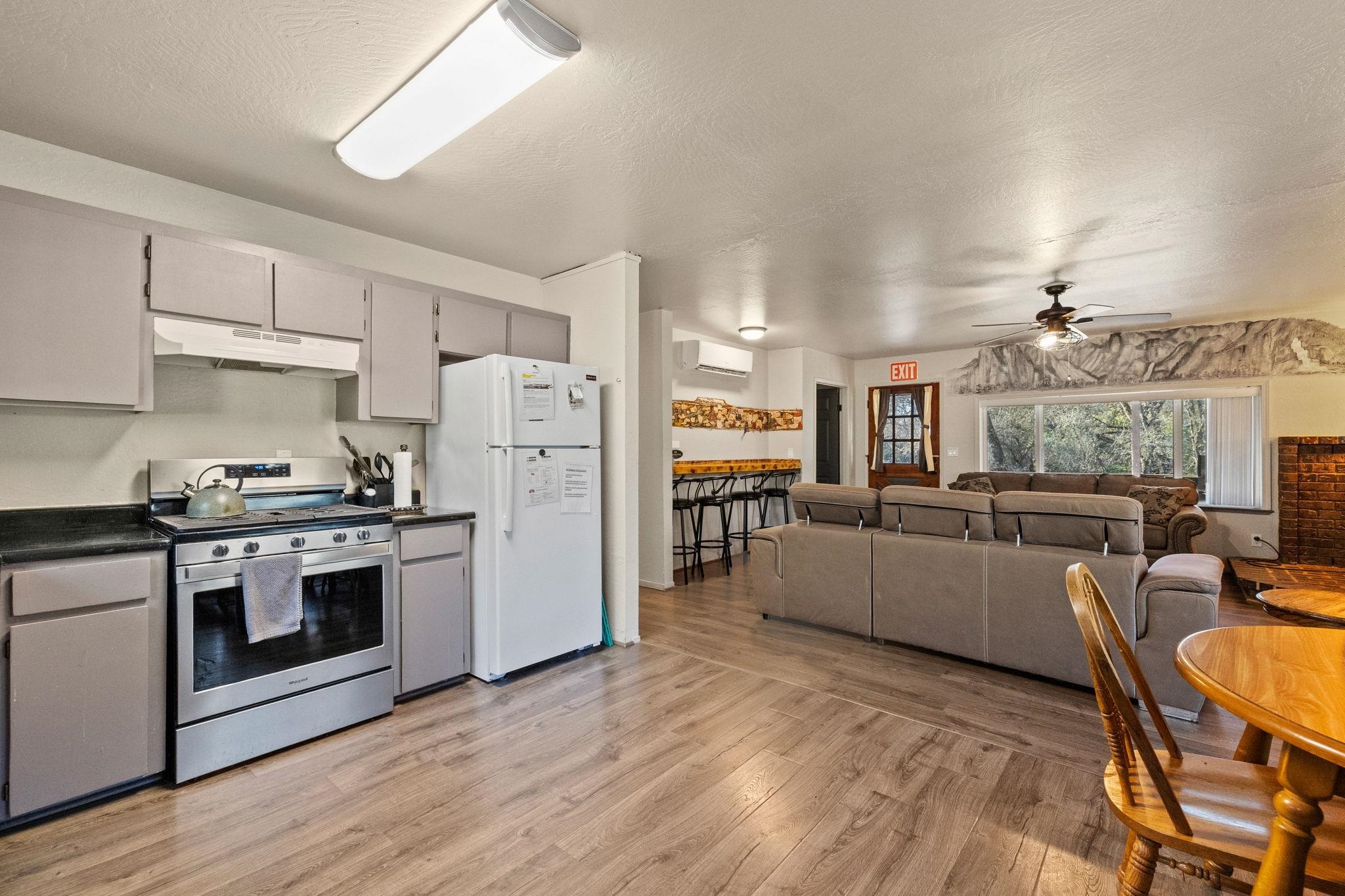 22941 Hudson Road Columbia, CA 95310 - Photo 5 of 34 Kitchen with stainless steel range, gray cabinetry, dark countertops, freestanding refrigerator, and a ceiling fan