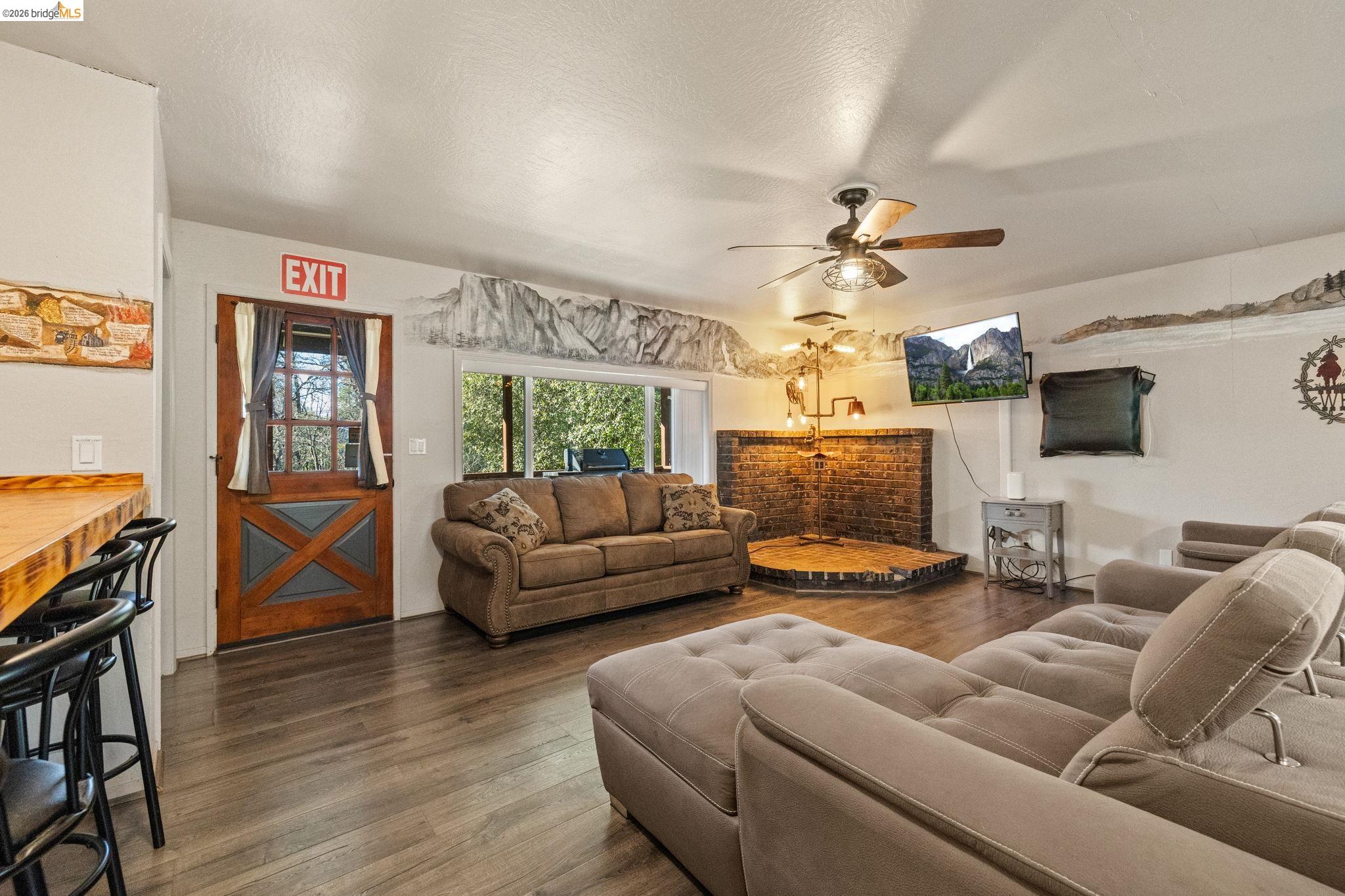 22941 Hudson Road Columbia, CA 95310 - Photo 10 of 34 a living room with furniture and a flat screen tv