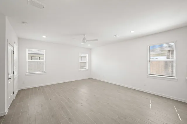 an empty room with windows and closet