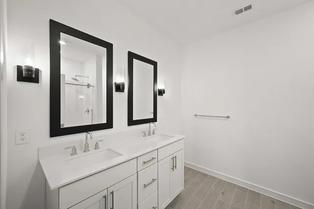 a bathroom with 2 sink and a mirror