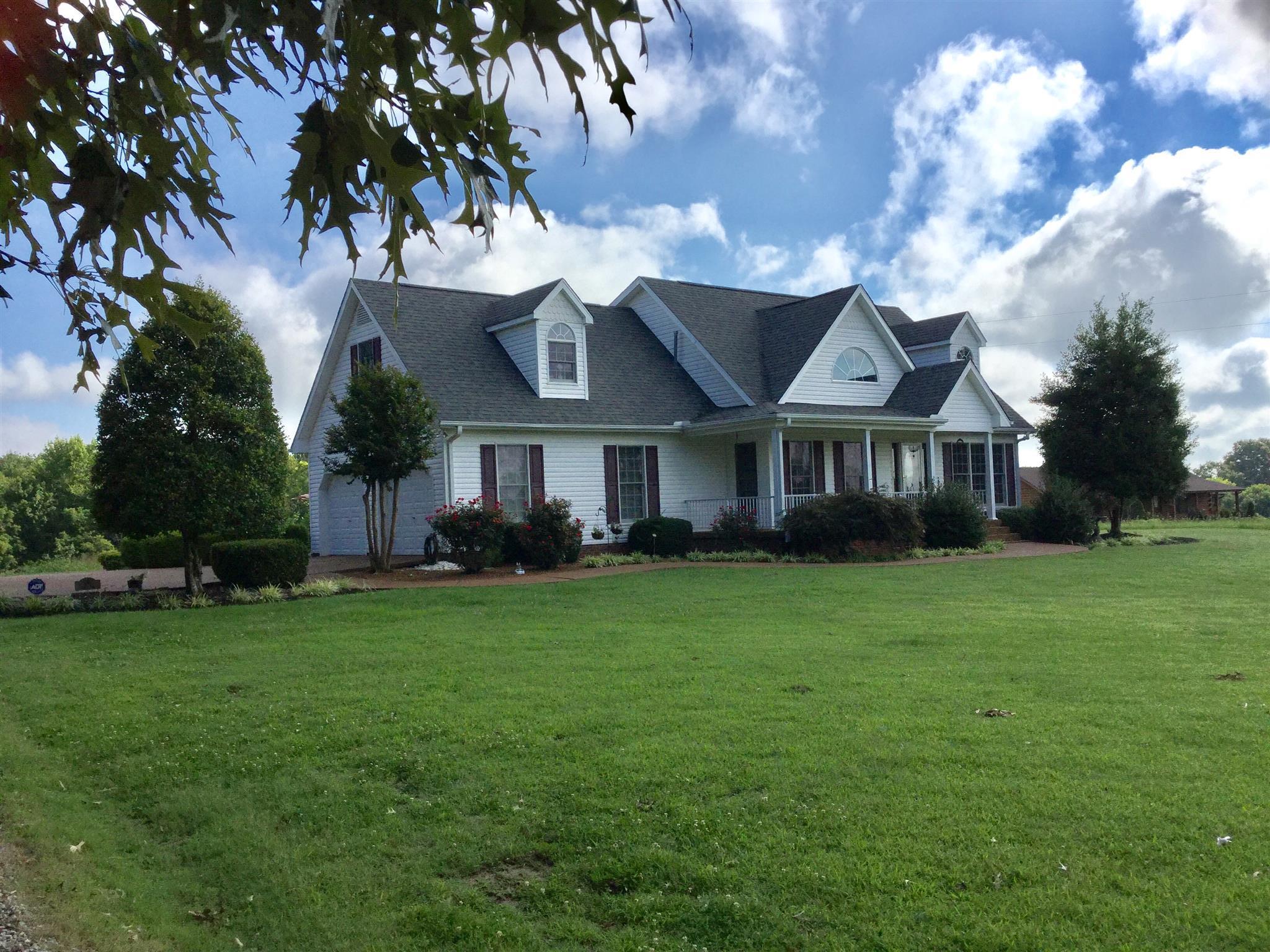 1901 Abiff Road Burns, TN 37029 - Photo 1 of 20 a front view of a house with a garden
