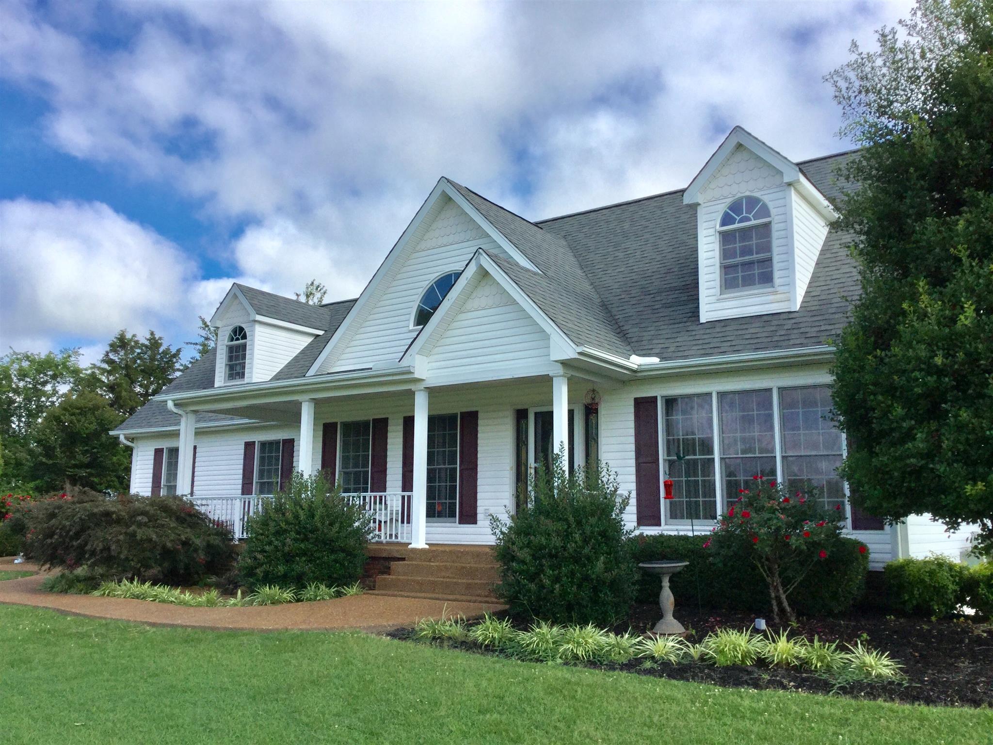1901 Abiff Road Burns, TN 37029 - Photo 2 of 20 a front view of a house with garden and trees