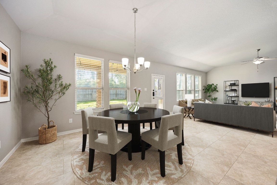 14023 Beaverhead Range Court Conroe, TX 77384 - Photo 12 of 29 A charming dining room serves as the perfect spot for family meals. Featuring gorgeous tile flooring, neutral-toned walls, large windows with fitted blinds, and chandelier lighting. *Virtually Staged