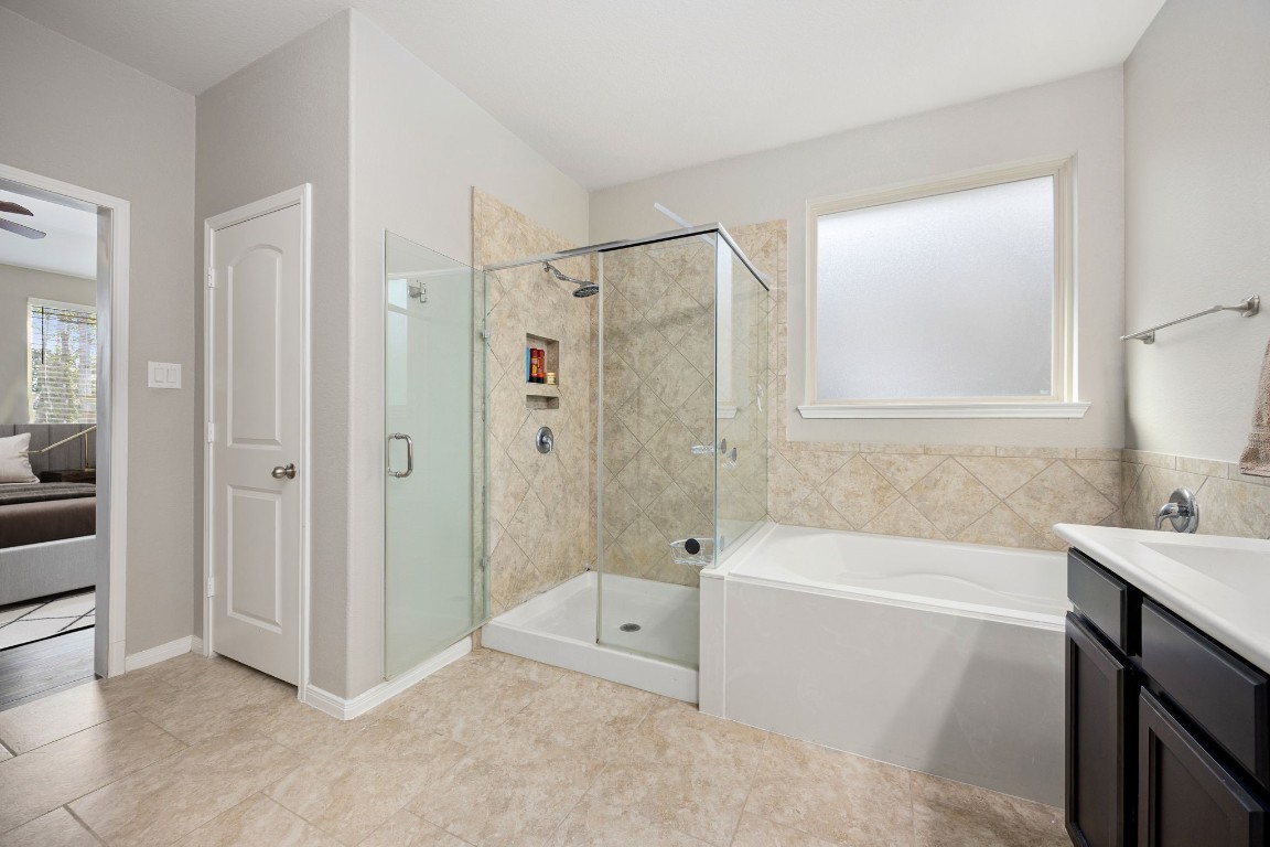 14023 Beaverhead Range Court Conroe, TX 77384 - Photo 16 of 29 This primary bathroom provides the best of both worlds, catering to both quick morning routines and relaxing evening soaks.