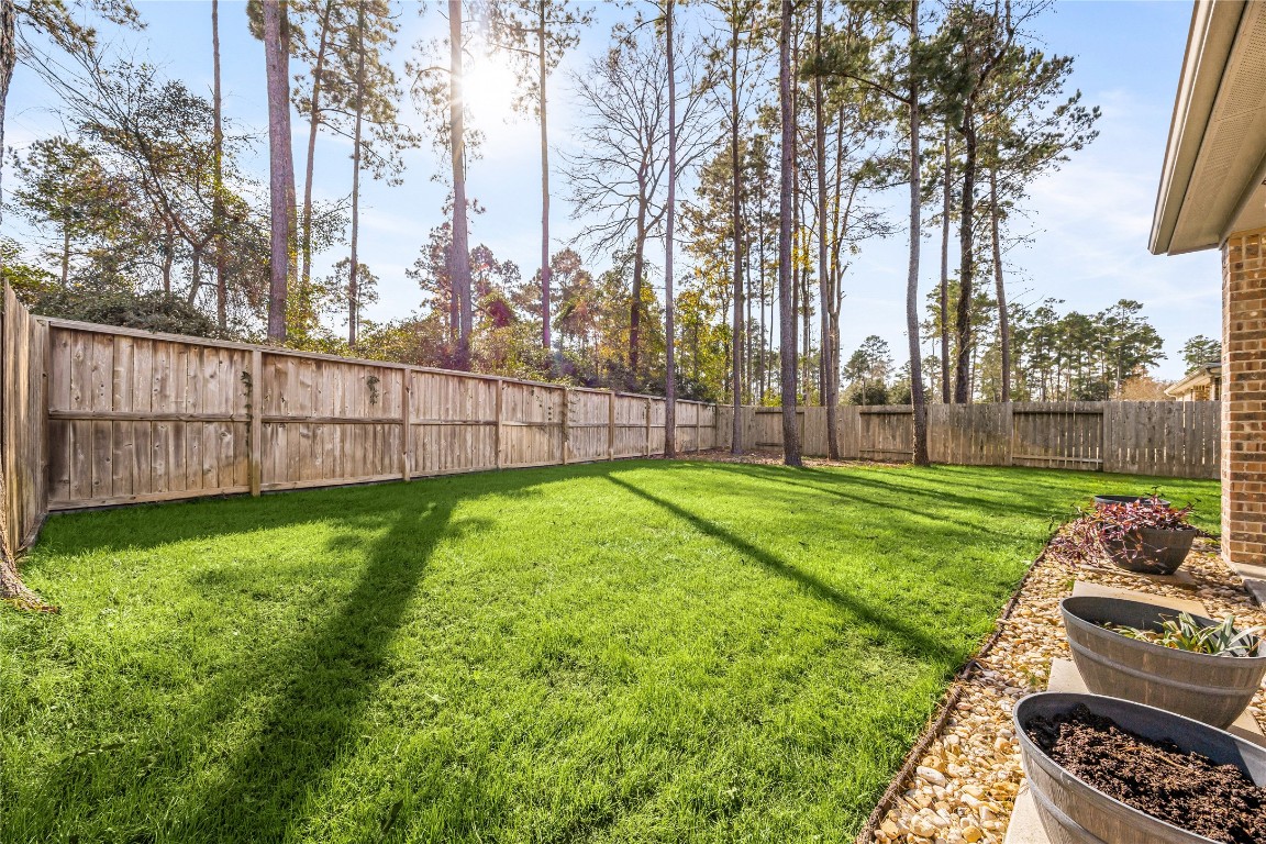 14023 Beaverhead Range Court Conroe, TX 77384 - Photo 23 of 29 The tall wooden privacy fence ensures a secluded environment, making the backyard a secure and peaceful retreat.
