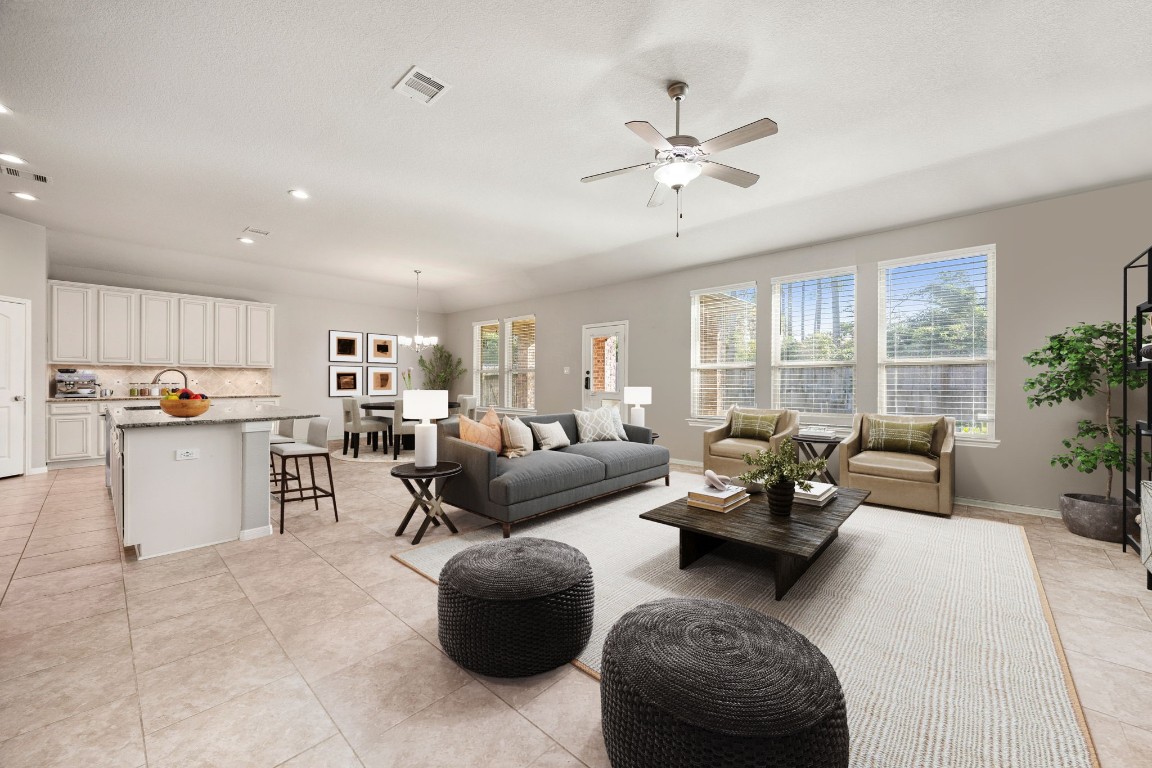 14023 Beaverhead Range Court Conroe, TX 77384 - Photo 29 of 29 Welcome to an inviting, open-concept living space perfect for both relaxing and entertaining! This bright and airy floor plan seamlessly connects the generous living room to the chef's kitchen and dining area, ensuring guests can easily mingle. With high ceilings and elegant tile flooring, this home strikes the perfect balance of comfort and modern design. *Virtually Staged