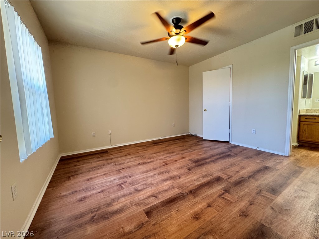 7255 West Sunset Road, Unit 2111 Las Vegas, NV 89113 - Photo 12 of 33 Well-appointed bedroom with warm wood-tone flooring and a ceiling fan for comfort.