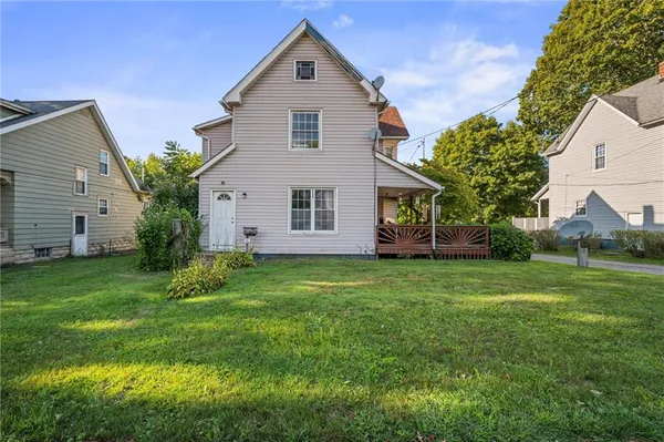 a front view of house with yard and green space