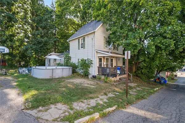 a view of a house with a yard and sitting area