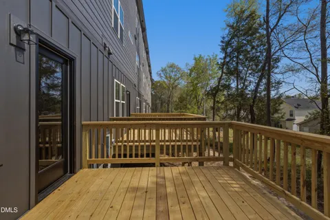 a view of balcony with wooden floor and fence