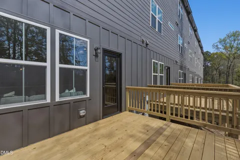 a view of balcony with wooden floor and fence