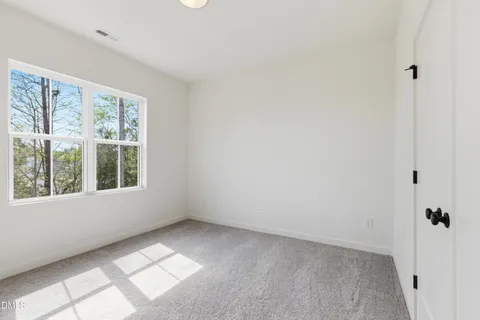 a bathroom with a sink a toilet a mirror and shower