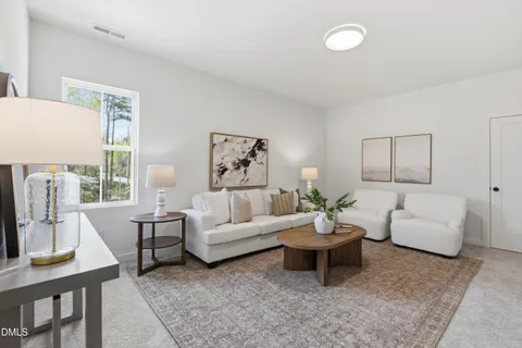 a living room with furniture and white walls