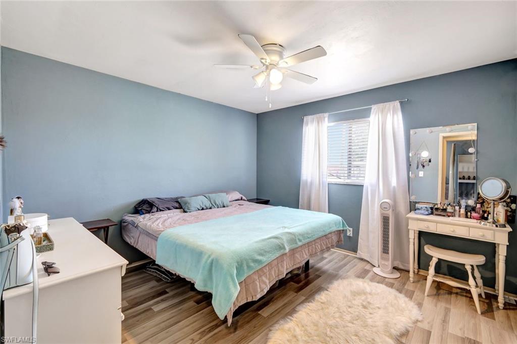 7481-7485 Pebble Beach Road Fort Myers, FL 33967 - Photo 11 of 31 a bedroom with a bed and a table in it