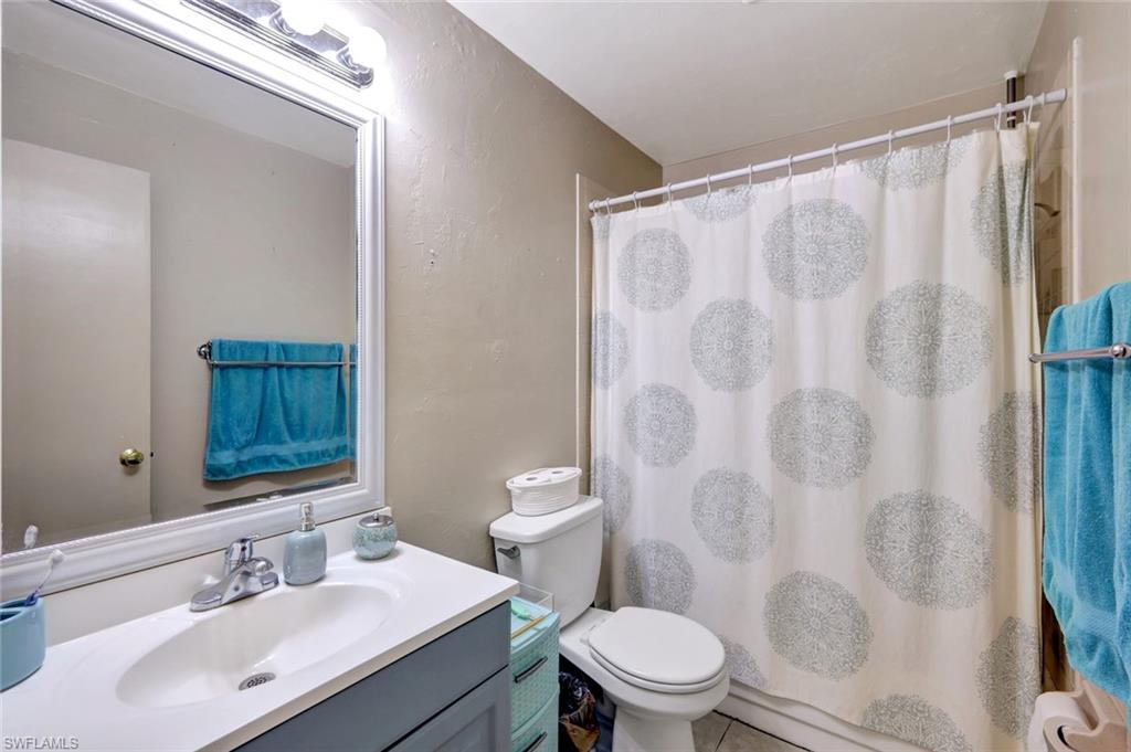 7481-7485 Pebble Beach Road Fort Myers, FL 33967 - Photo 12 of 31 a bathroom with a sink and a mirror