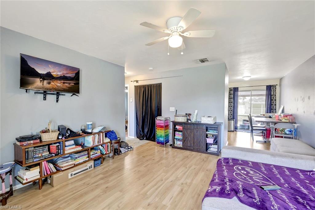 7481-7485 Pebble Beach Road Fort Myers, FL 33967 - Photo 19 of 31 a living room with furniture and a flat screen tv