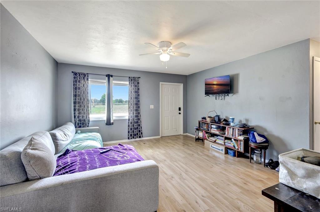 7481-7485 Pebble Beach Road Fort Myers, FL 33967 - Photo 21 of 31 a bedroom with furniture and a flat screen tv