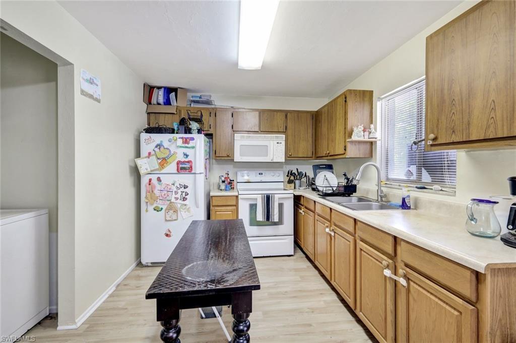 7481-7485 Pebble Beach Road Fort Myers, FL 33967 - Photo 25 of 31 a kitchen with stainless steel appliances granite countertop a refrigerator sink and stove