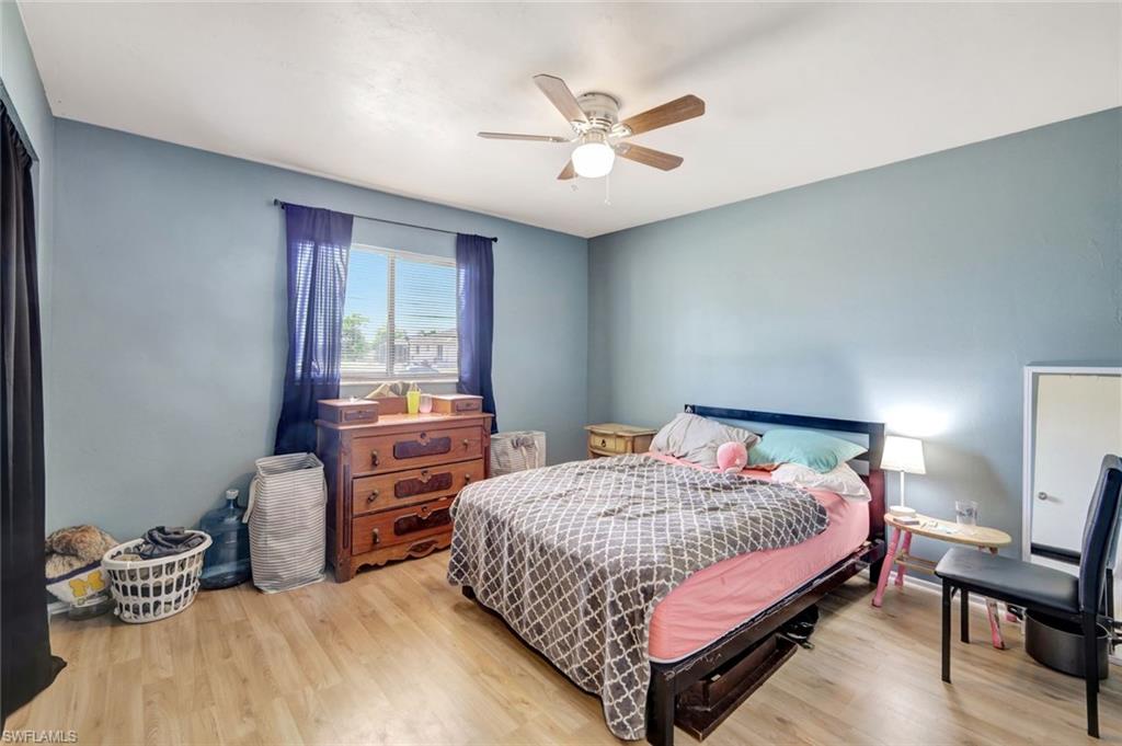 7481-7485 Pebble Beach Road Fort Myers, FL 33967 - Photo 26 of 31 a bedroom with a bed and a chandelier