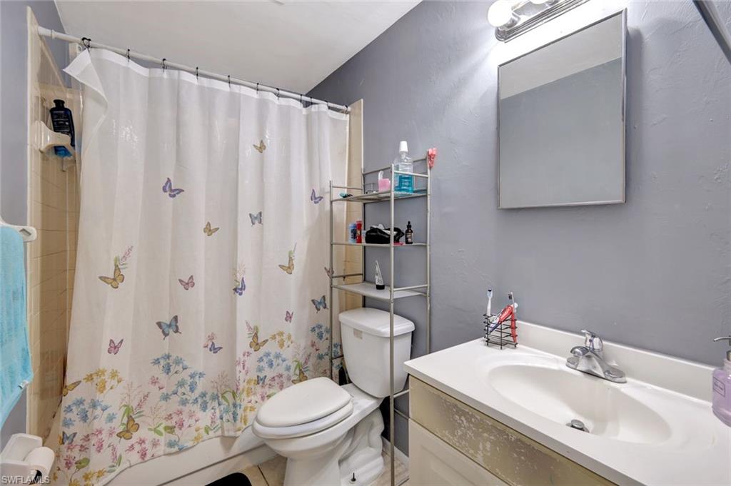 7481-7485 Pebble Beach Road Fort Myers, FL 33967 - Photo 27 of 31 a bathroom with a sink toilet and shower