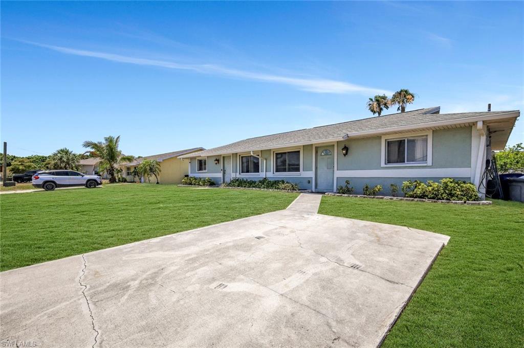 7481-7485 Pebble Beach Road Fort Myers, FL 33967 - Photo 3 of 31 a view of house with a yard