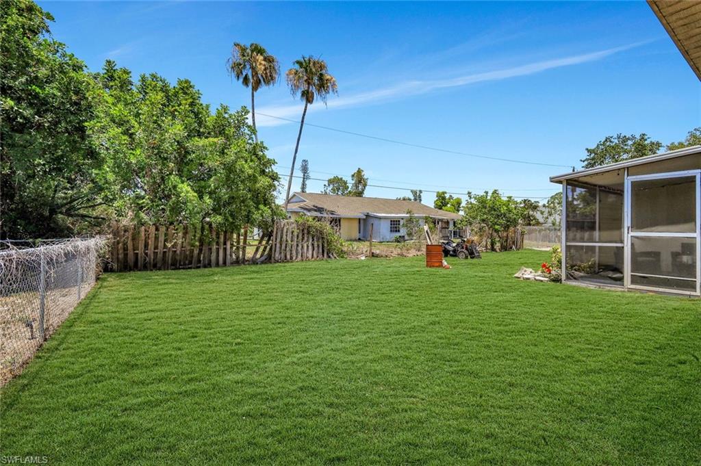 7481-7485 Pebble Beach Road Fort Myers, FL 33967 - Photo 31 of 31 a view of a house with a backyard