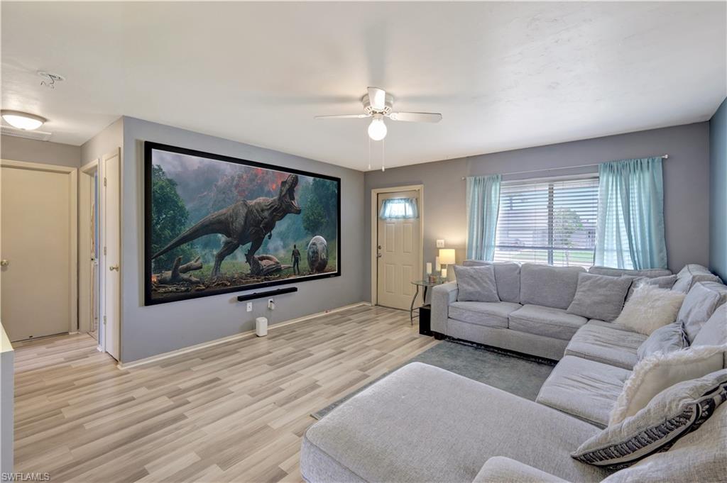 7481-7485 Pebble Beach Road Fort Myers, FL 33967 - Photo 5 of 31 a living room with furniture and a large window