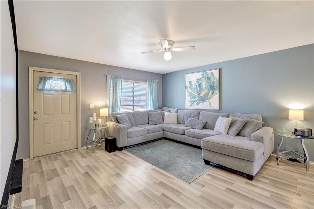 7481-7485 Pebble Beach Road Fort Myers, FL 33967 - Photo 6 of 31 a living room with furniture and a large window