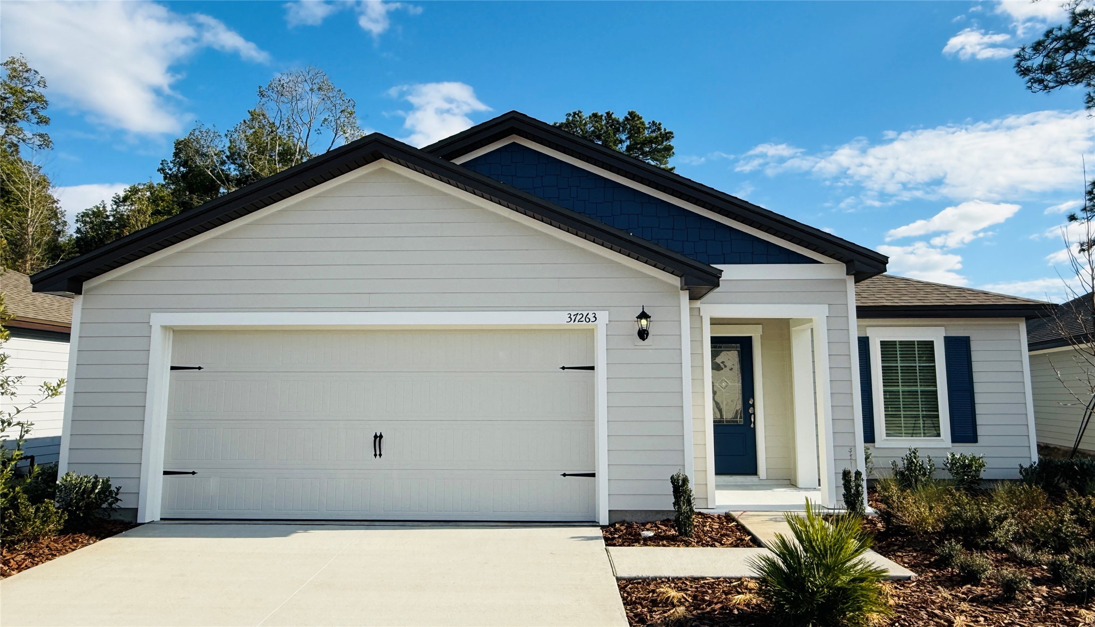 37263 Whisper Way Hilliard, FL 32046 - Photo 1 of 6 a front view of a house with a yard