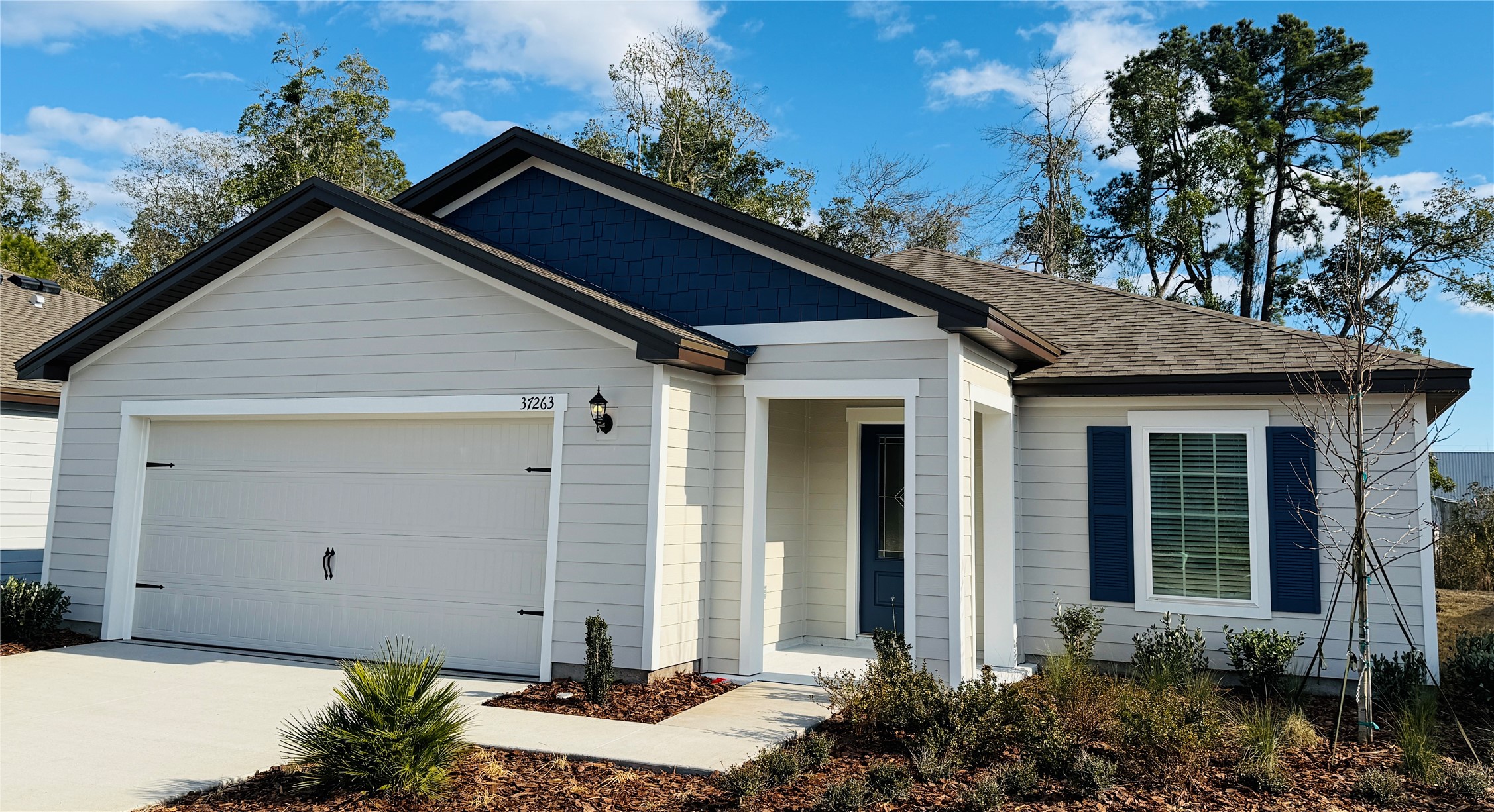 37263 Whisper Way Hilliard, FL 32046 - Photo 2 of 6 a front view of a house with a yard