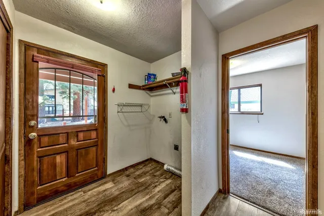 a view of hallway with stairs and wooden floor