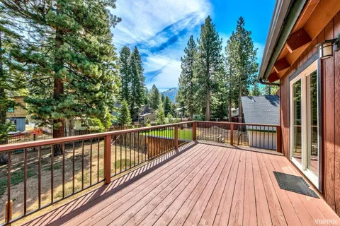 a view of balcony with wooden floor and fence