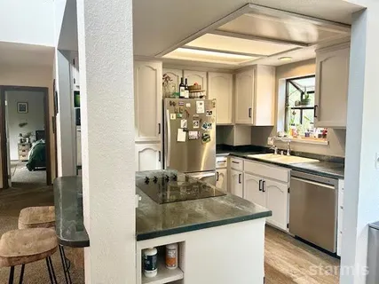 a kitchen with a sink stove and refrigerator