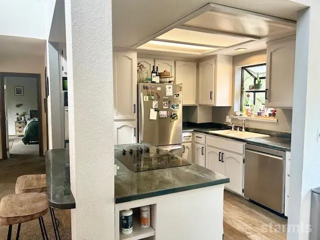 a kitchen with a sink stove and refrigerator