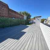 a view of a wooden deck with a yard