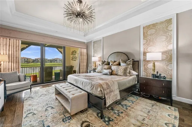 a bedroom with a bed couch and large window