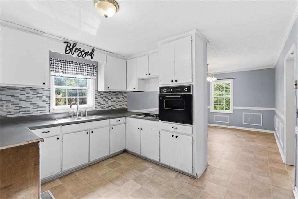 1500 Moores Ferry Road Southwest Plainville, GA 30733 - Photo 24 of 33 a kitchen with granite countertop a sink cabinets stainless steel appliances and a window