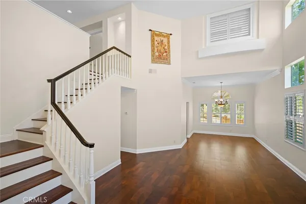 a view of an entryway with wooden floor and windows
