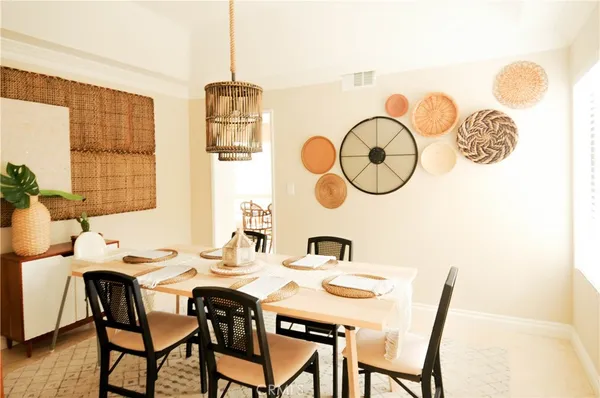 a dining room with furniture and window