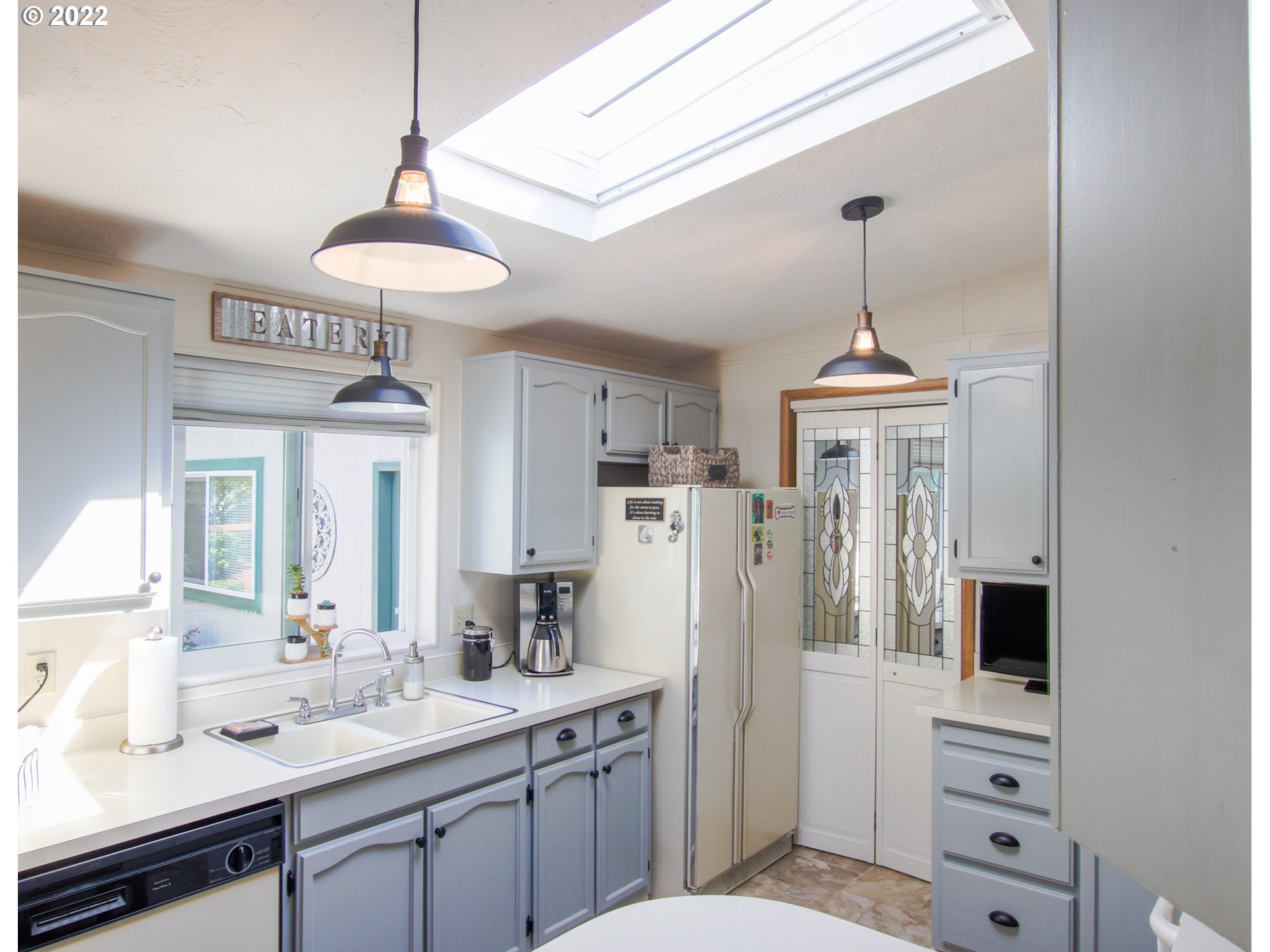 2187 12th Street Florence, OR 97439 - Photo 12 of 30 a spacious bathroom with a sink a toilet and a mirror