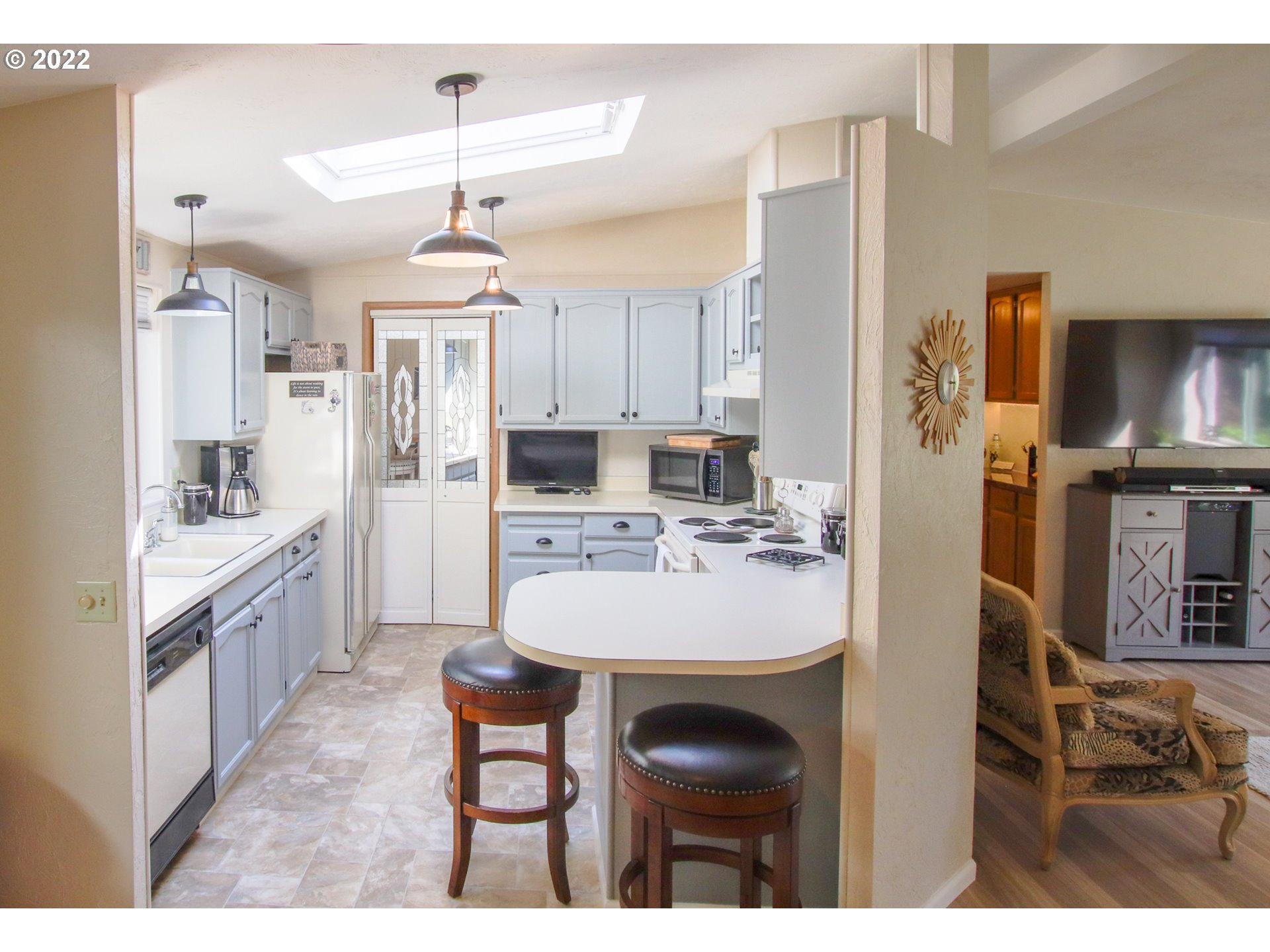 2187 12th Street Florence, OR 97439 - Photo 13 of 30 a kitchen with kitchen island granite countertop a sink stove and refrigerator