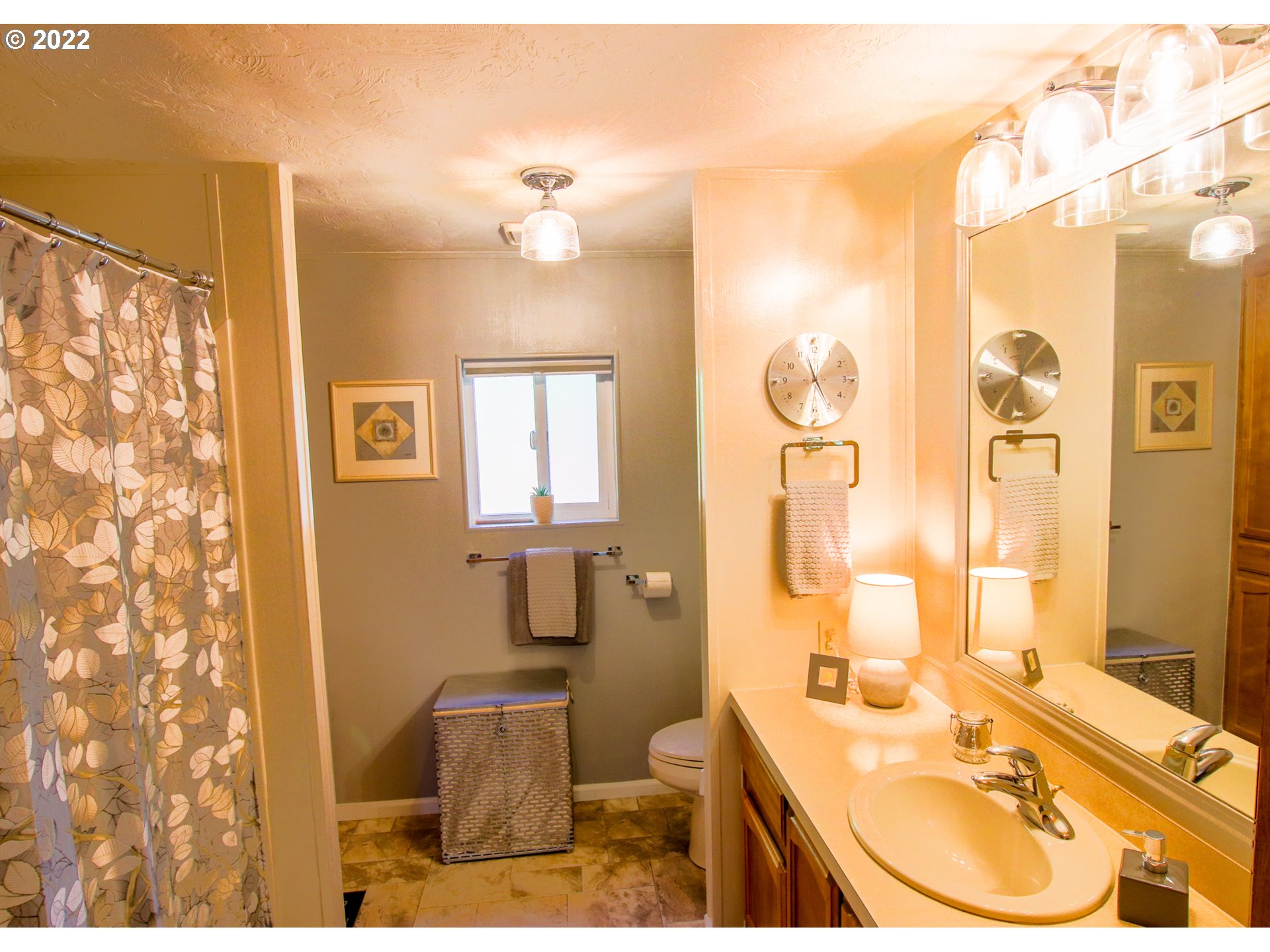 2187 12th Street Florence, OR 97439 - Photo 20 of 30 a bathroom with a sink toilet tub and shower