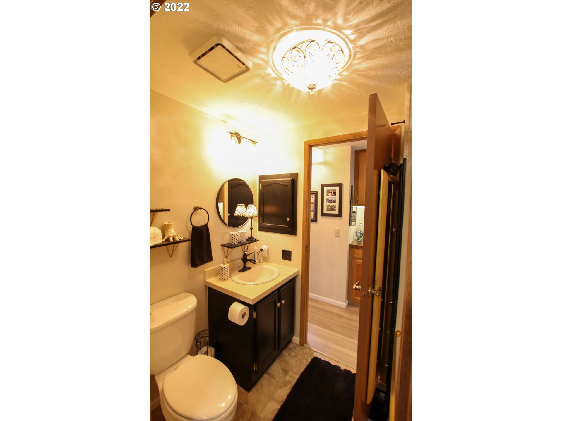 2187 12th Street Florence, OR 97439 - Photo 26 of 30 a bathroom with a toilet sink and mirror