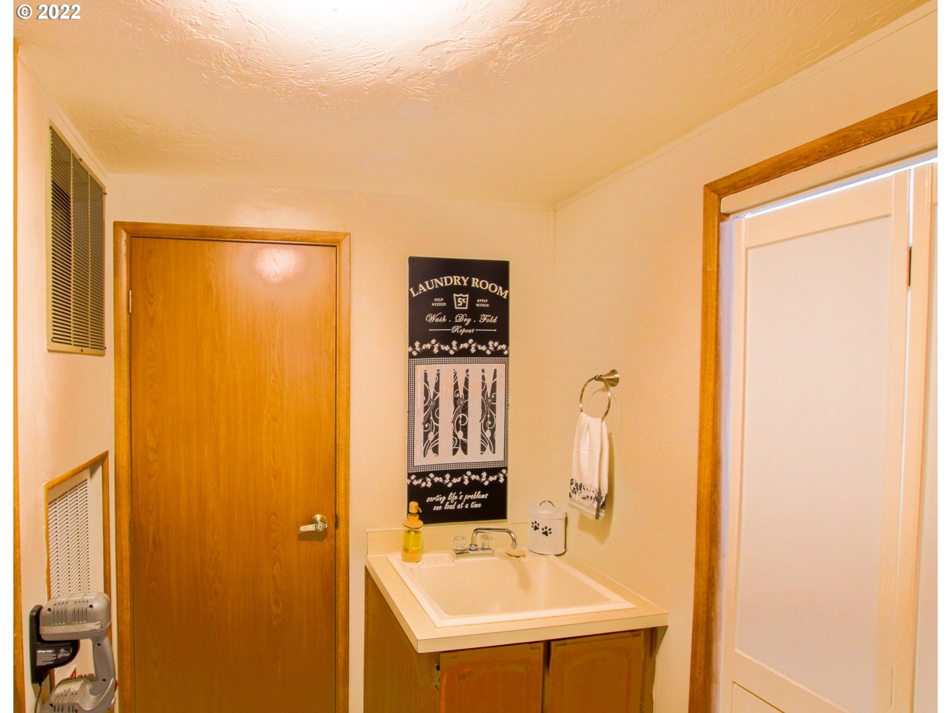 2187 12th Street Florence, OR 97439 - Photo 27 of 30 a bathroom with a sink a mirror and a shower