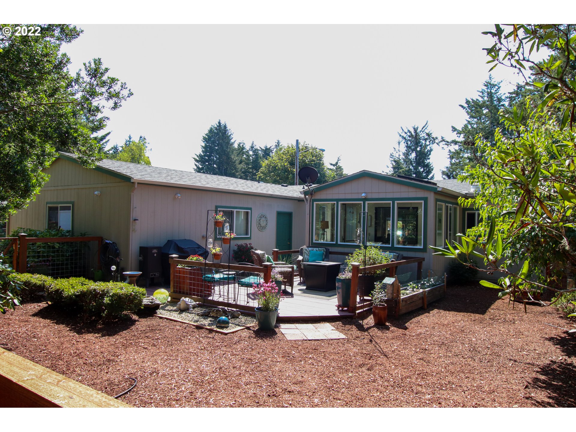 2187 12th Street Florence, OR 97439 - Photo 3 of 30 a backyard of a house with table and chairs