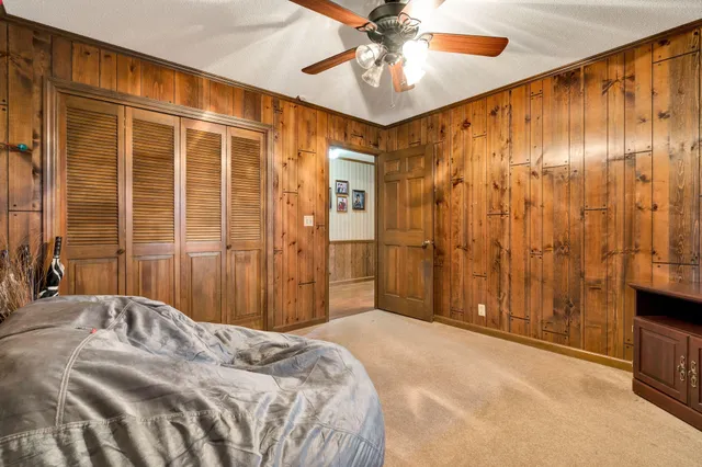 a room with a table chairs and a window