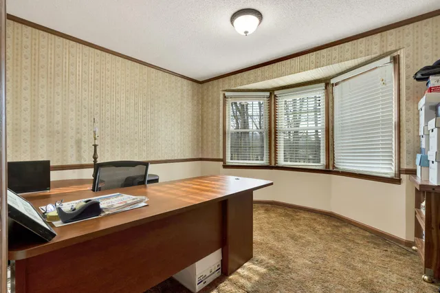 a view of a house with a wooden deck
